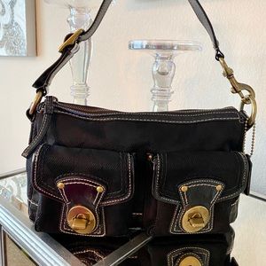Black Coach handbag. With brushed gold hardware .